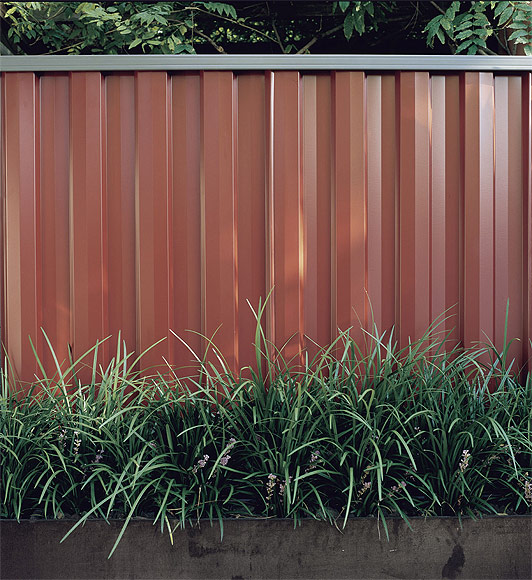 Fencing made from COLORBOND® steel in colour Red Oak®
